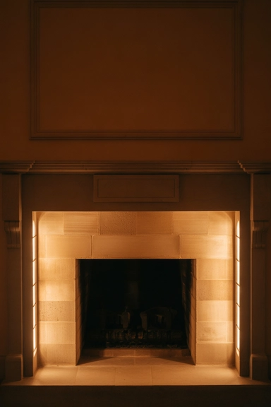 Use Lighting to Support the Fireplace, Not Compete With It