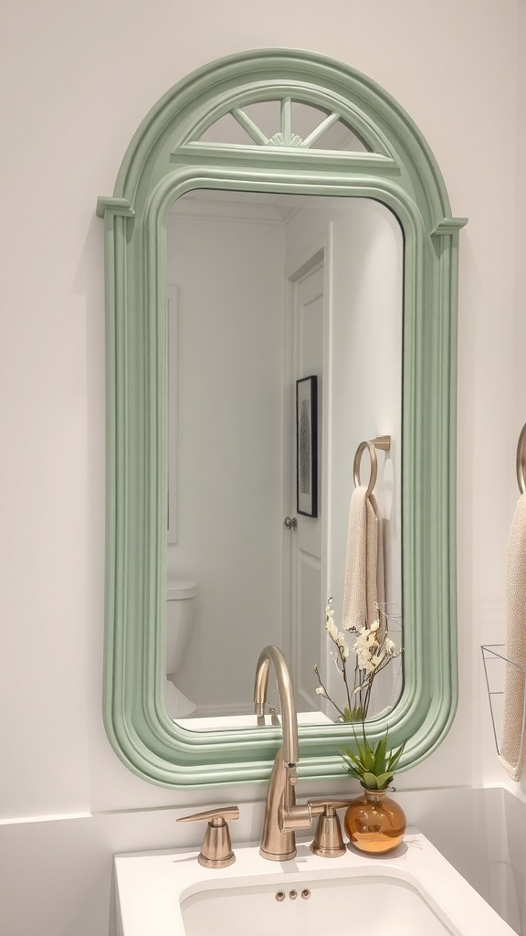 A sage green framed mirror in a bathroom, featuring a stylish design and a light background.
