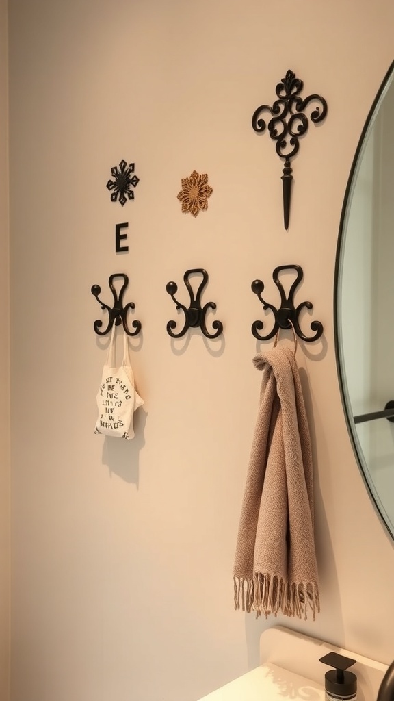 A bathroom wall featuring decorative black hooks with a towel and a small bag hanging on them.